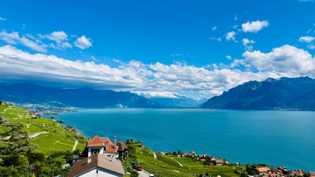 Stunning aerial view of Lake Geneva, vineyards, and mountains from Chexbres, Switzerland.